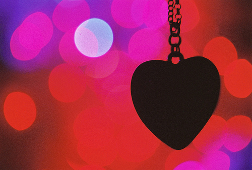 Heart Pendant Silhouette with Red Twinkling Background